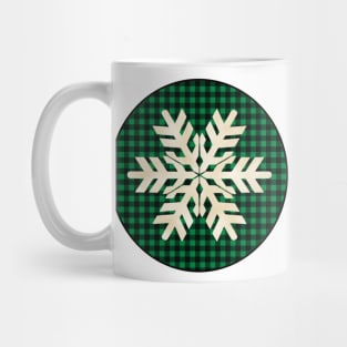 Snowflake silhouette over a black and green tile pattern Mug